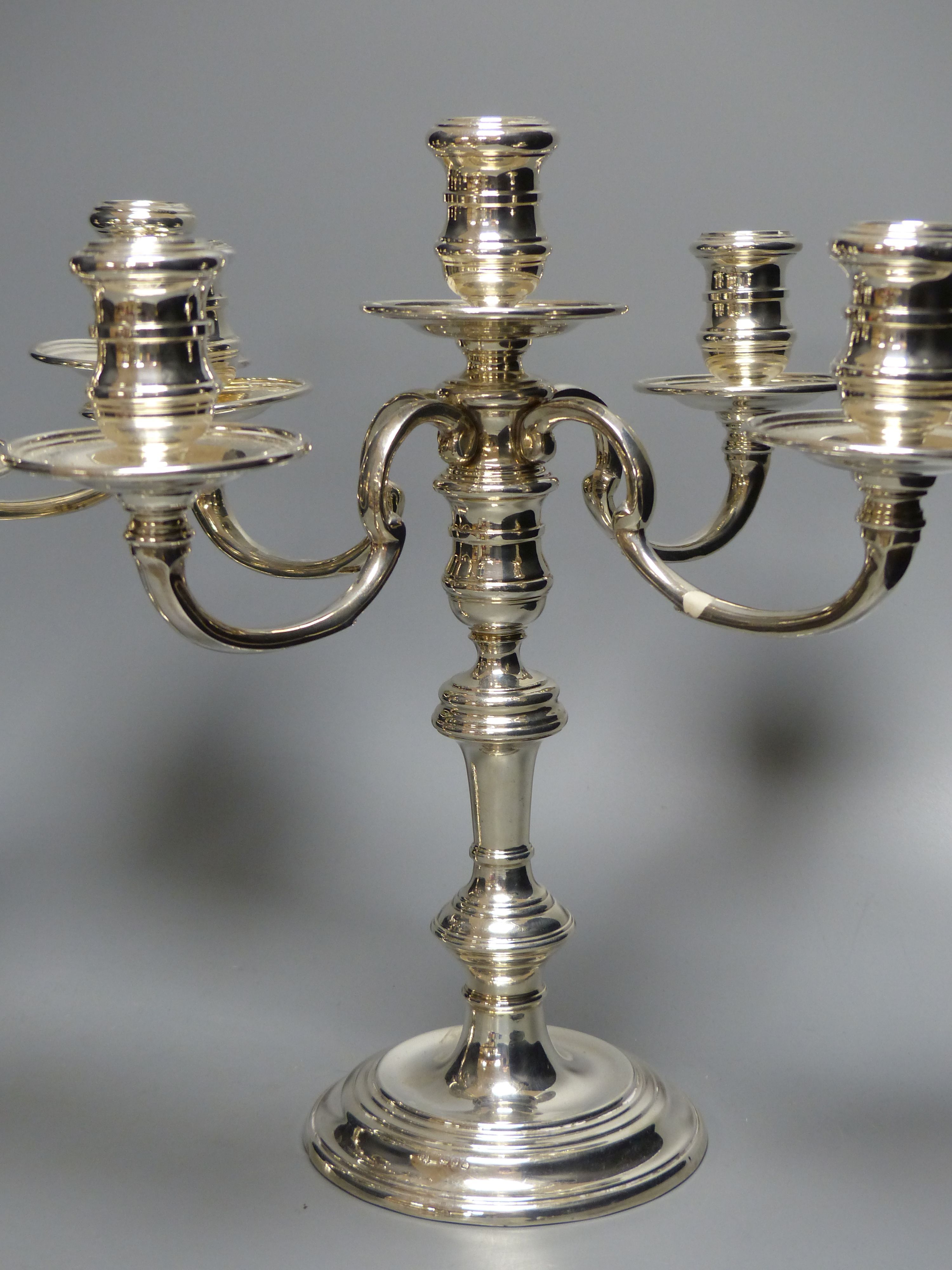 A pair of Georgian style silver four-branch five-light candelabra,